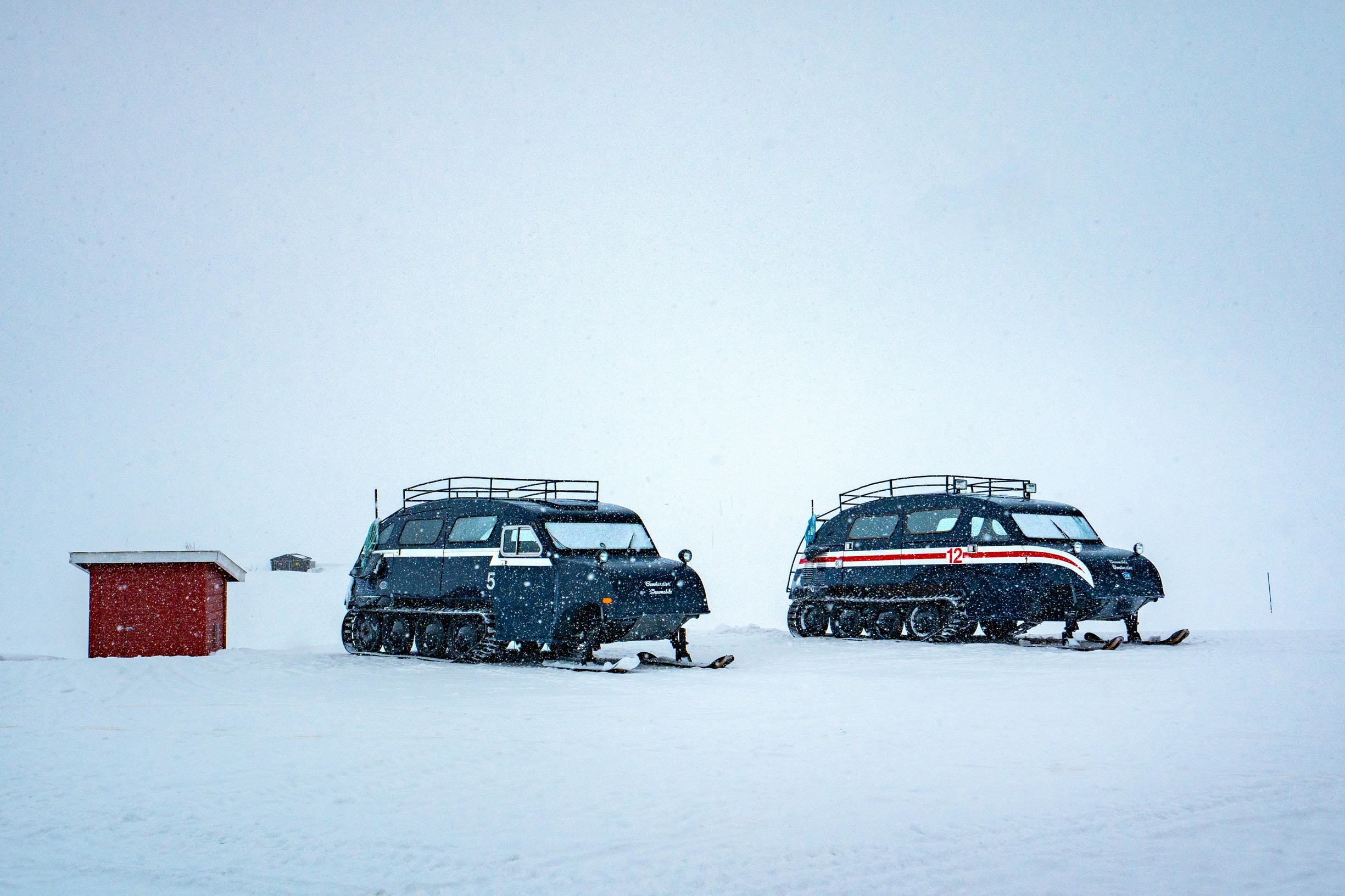 Snow coaches by Tyin lake