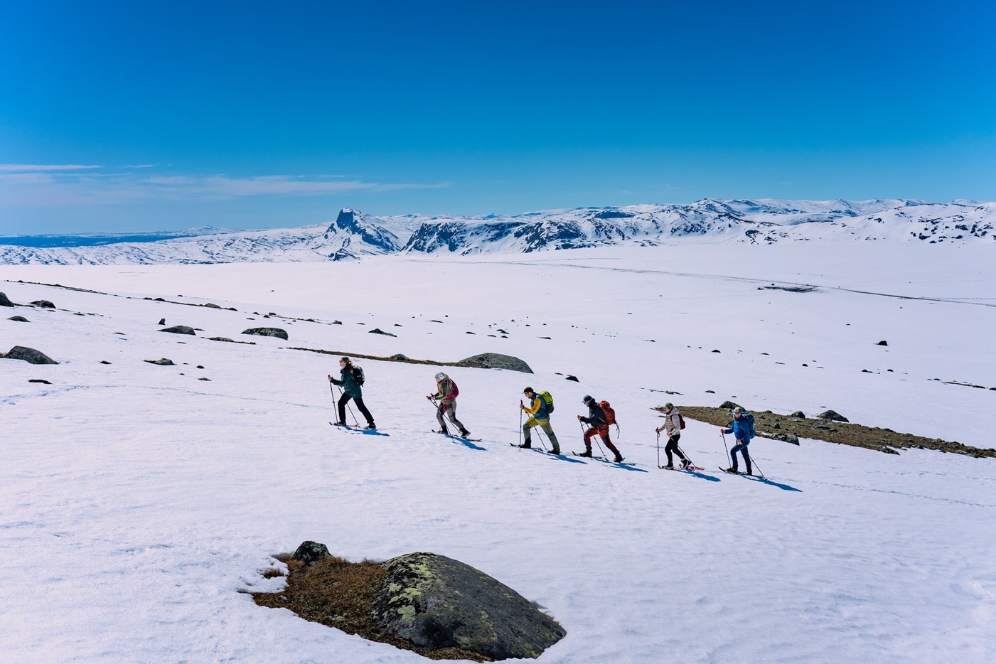 A group hikes with snowshoes through Norway winter